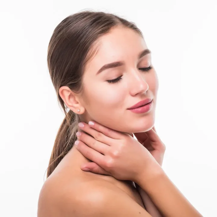 Beautiful sensual woman touching her face. Beauty and skincare concept. Spa. Isolated over white.